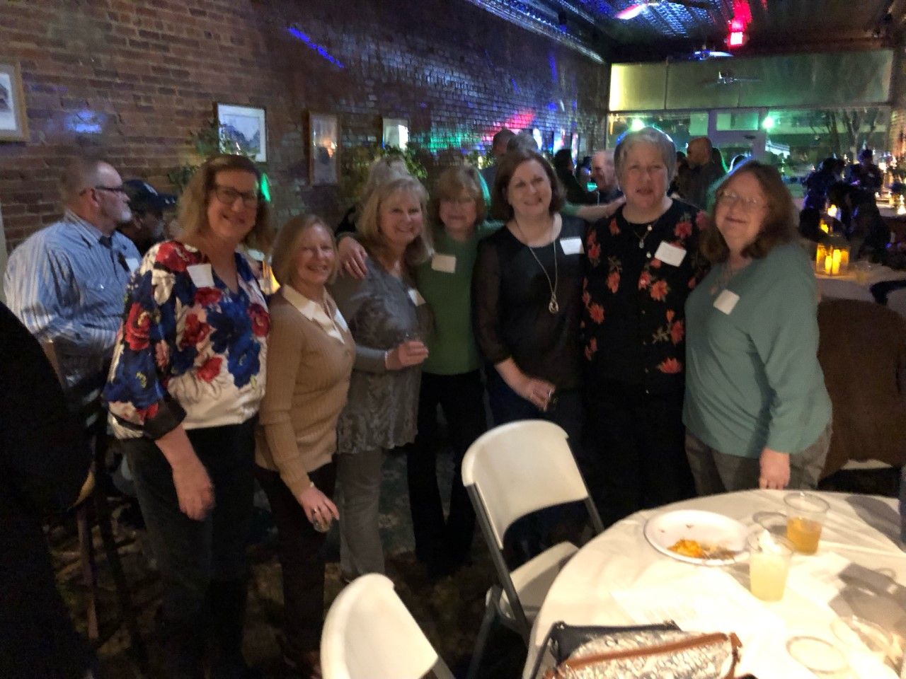 A group of women are posing for a picture in a restaurant.