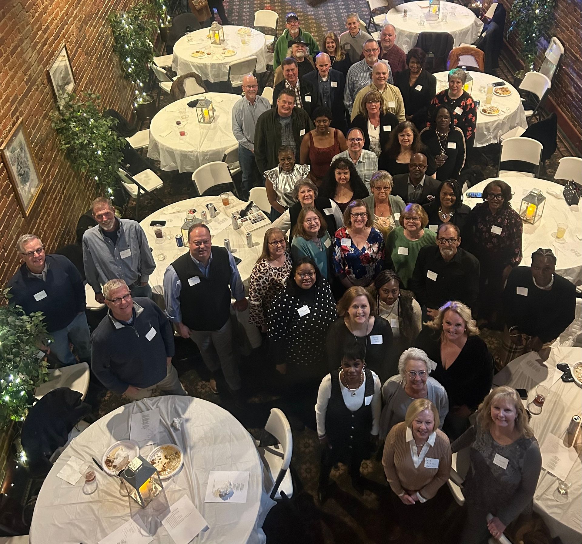 A large group of people are posing for a picture in a restaurant