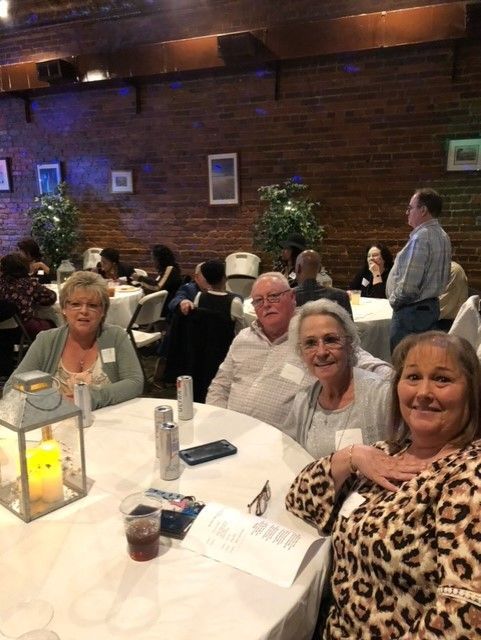 A group of people are sitting at tables in a room.