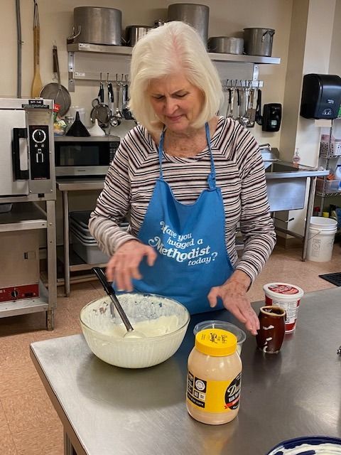 A volunteer is prepping food in the kitchen