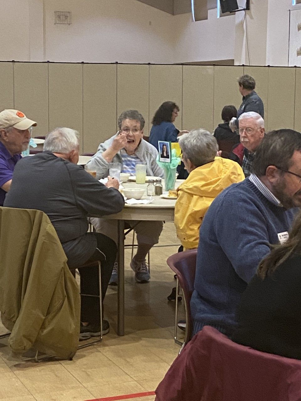 A group of people are sitting at tables in a room