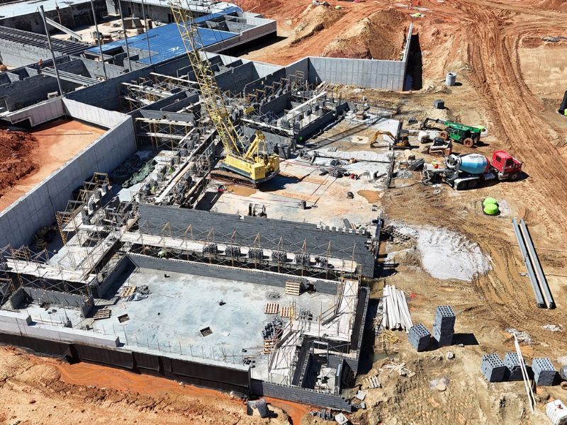 An aerial view of a construction site with a large building under construction.