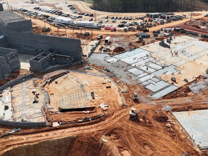 An aerial view of a construction site with a large building under construction.