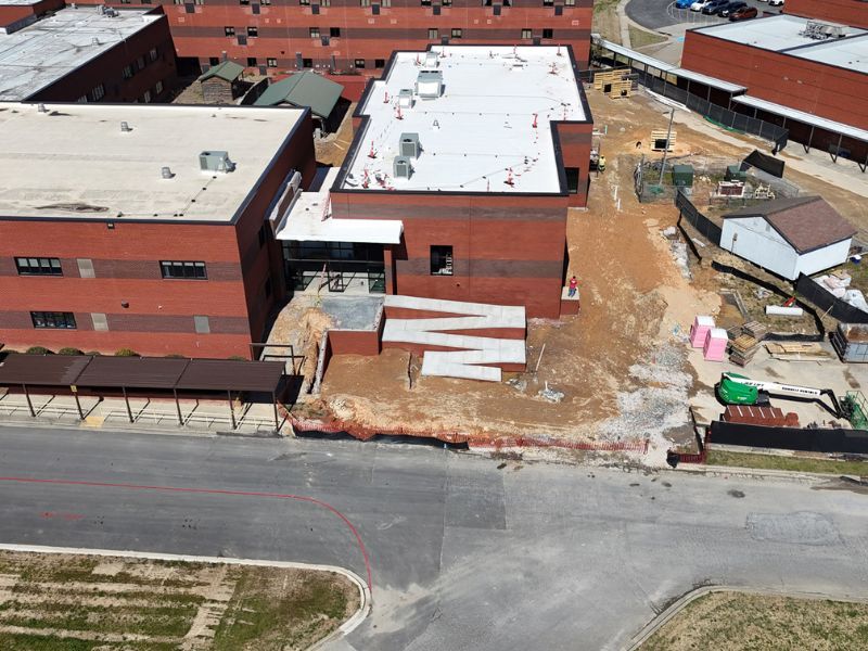 An aerial view of a large brick building under construction.