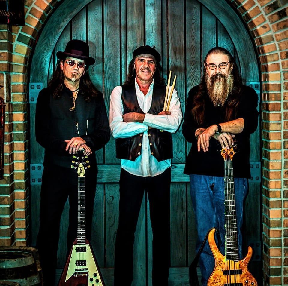 A man wearing headphones is singing into a microphone