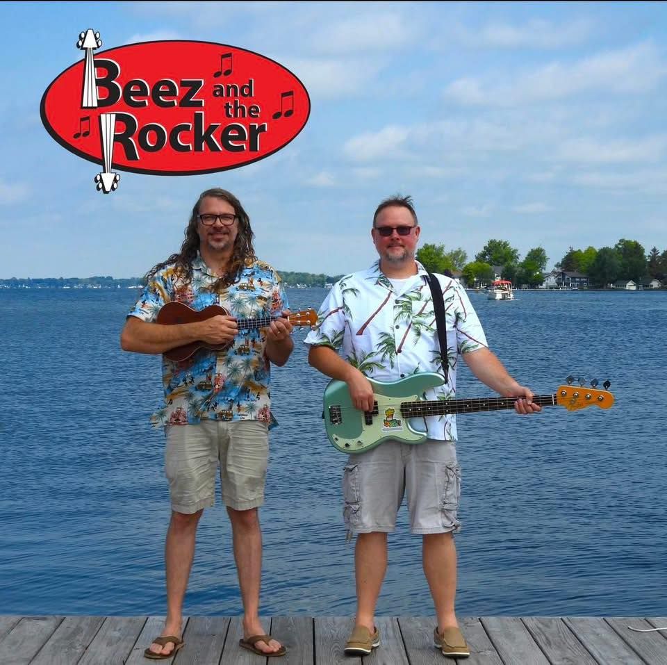 A woman standing next to a guitar case on a snowy path