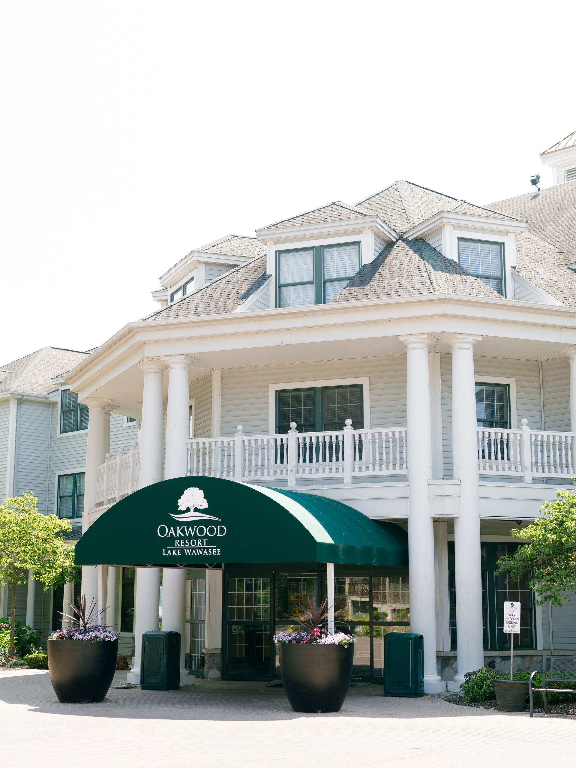 A large white building with a green awning over the entrance