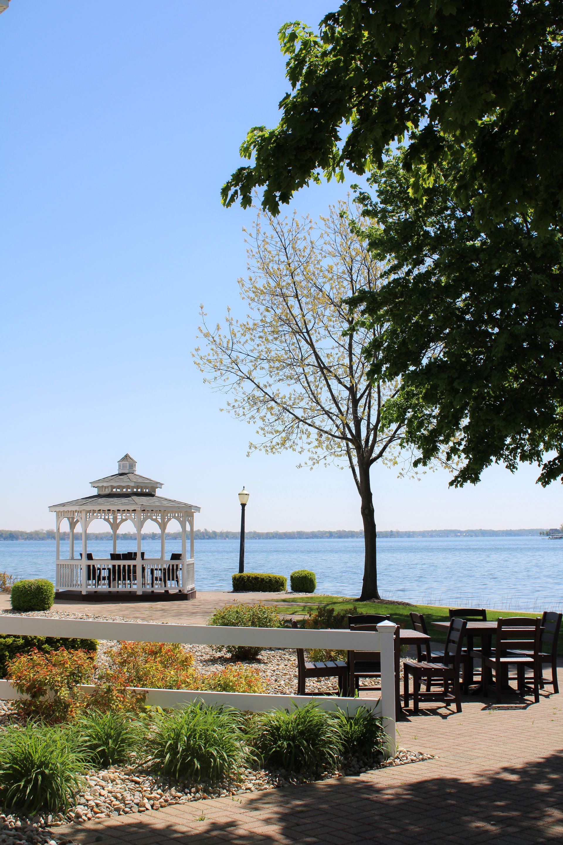 A gazebo sits on the shore of a lake
