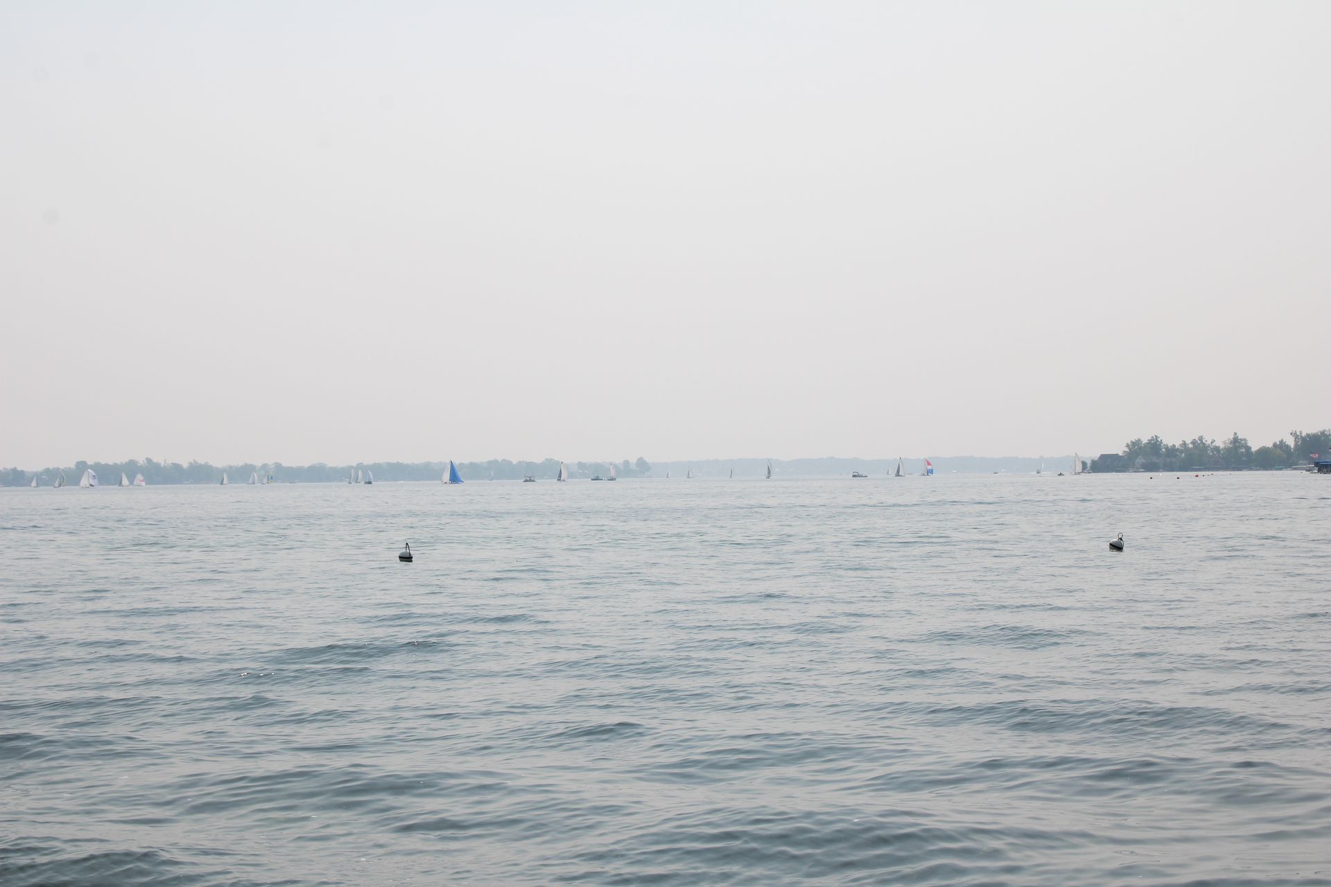 A large body of water with boats in the distance.