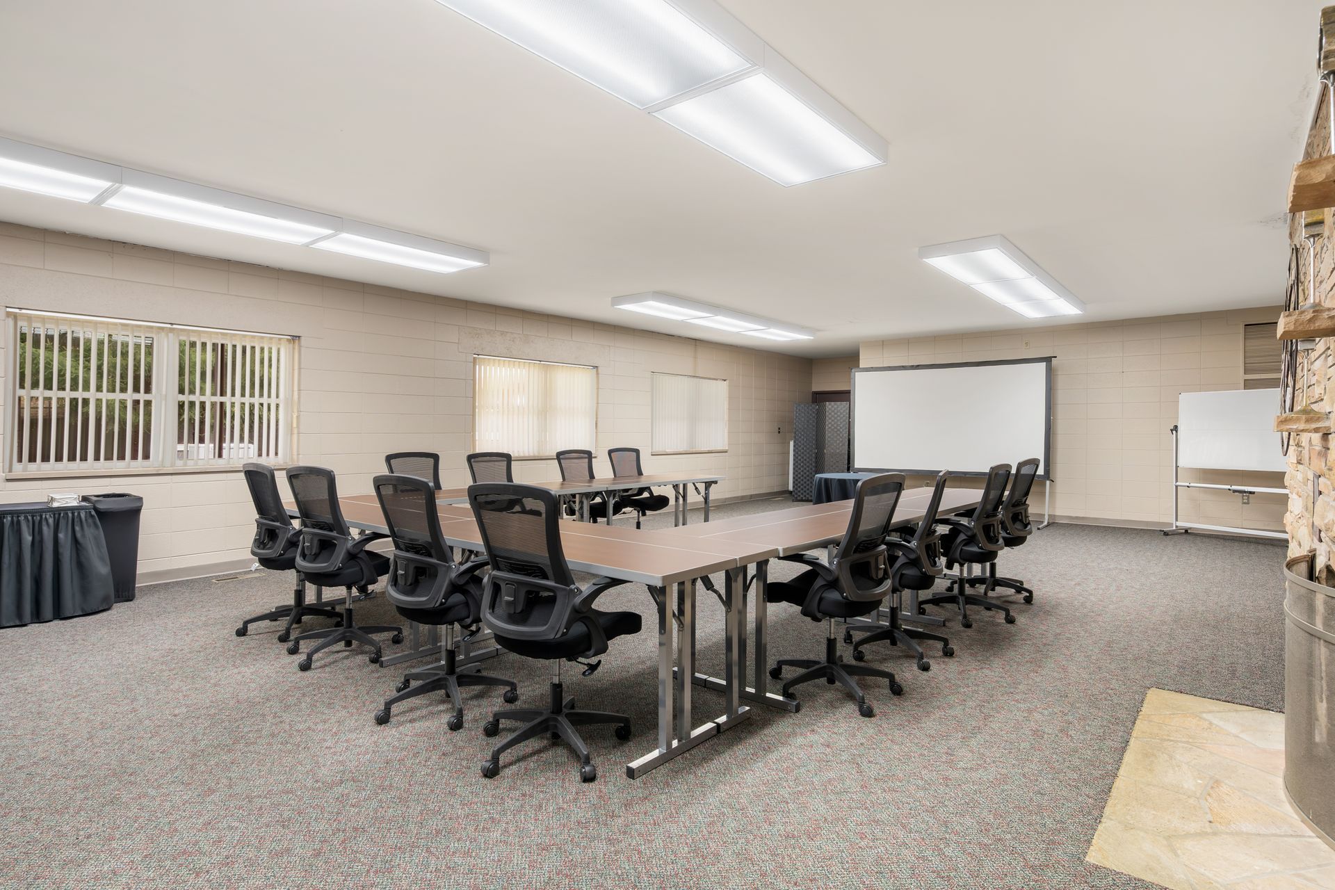 A large conference room with a long table and chairs.