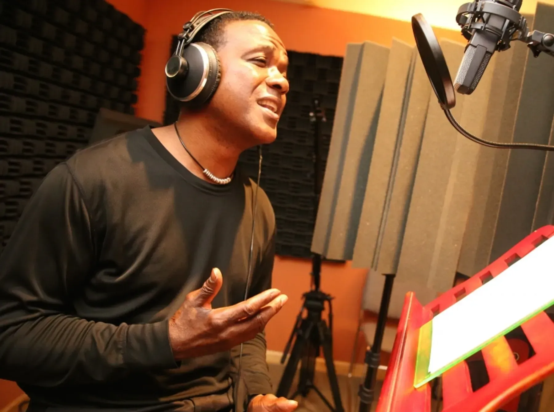 A woman standing next to a guitar case on a snowy path