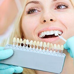 Bridges & Crowns — Dentist Fitting Dental Crown to a Woman in Burlington, IA