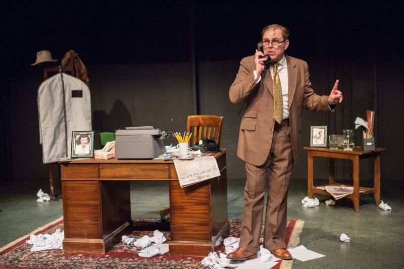 Bernie standing near desk listening to someone on phone