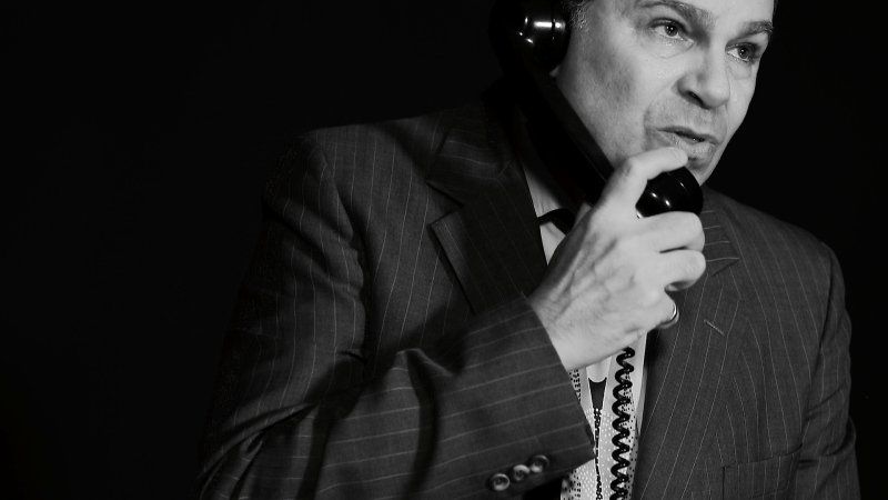 Bernie talking on phone in his right hand in this black and white picture