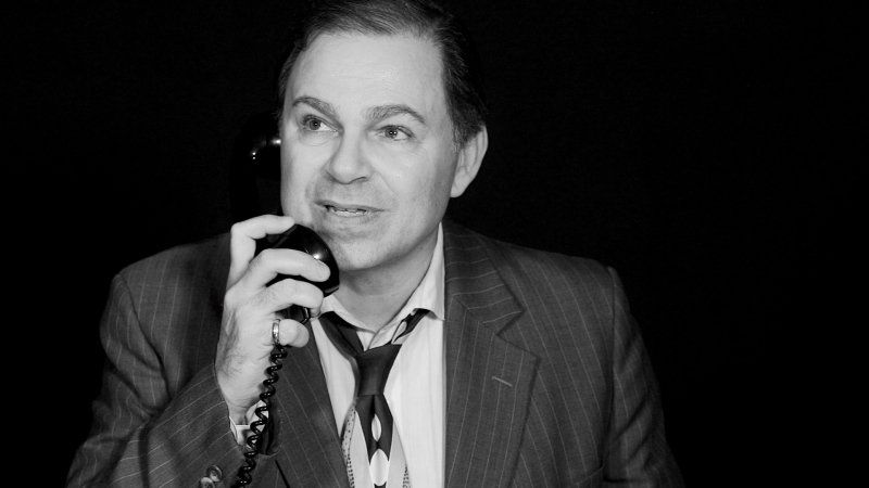 Bernie, looking hopeful, reacts to  news he hears on the phone.