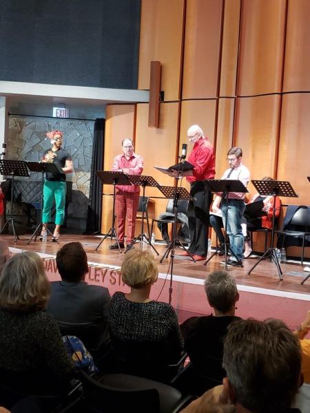 1 actor in green pants and nightcap and 3 more actors on stage during  a scene