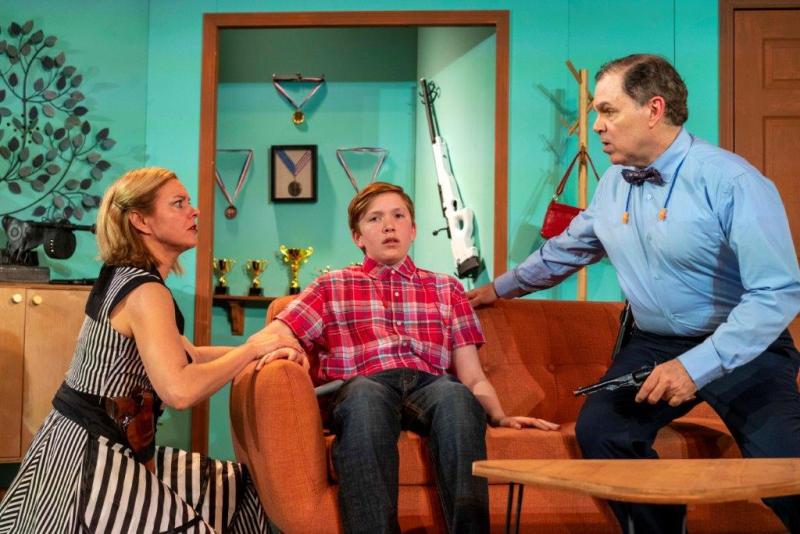 Mother and unhappy son wearing gun belts and father  discussing son's future.