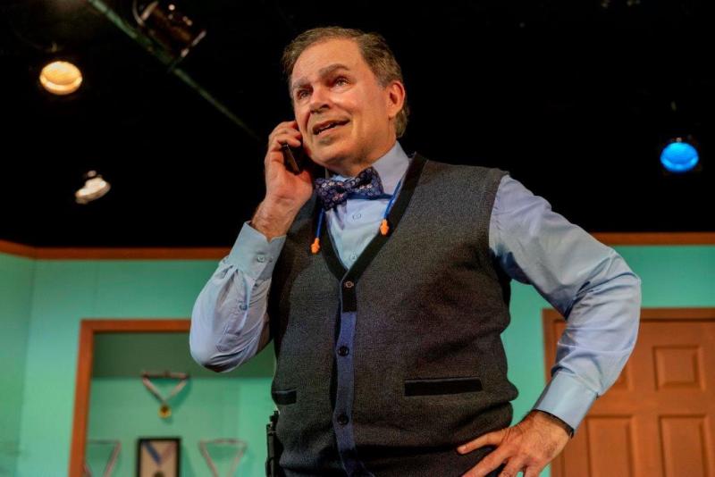 Father in sweater vest on the phone.