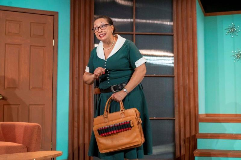 Social worker holding purse with bullets on outside.