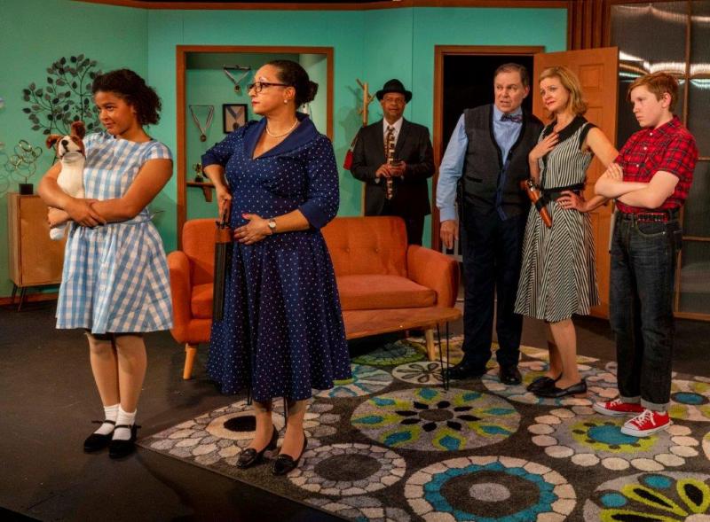 6 cast members standing in living room at the end of the play.