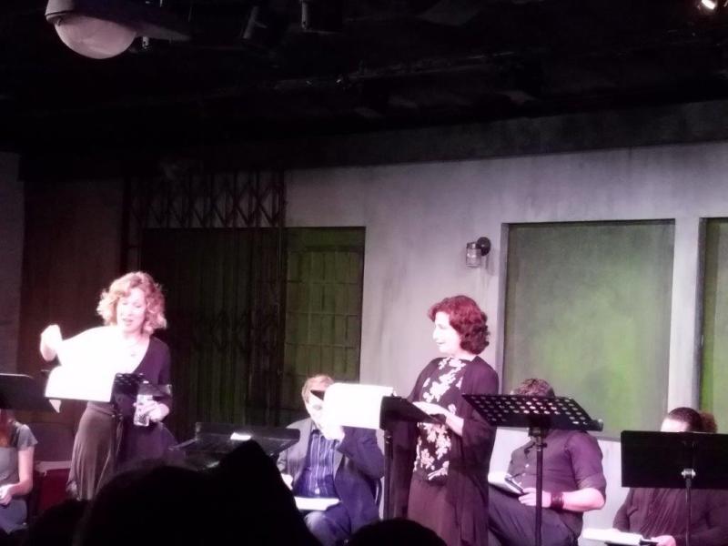 2 actors standing at music stands presenting a scene from The Little Foxes.