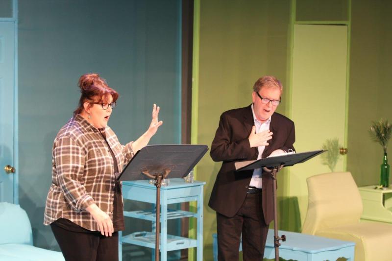 Both woman in brown checked shirt and man in brown suit looking excited during conversation.