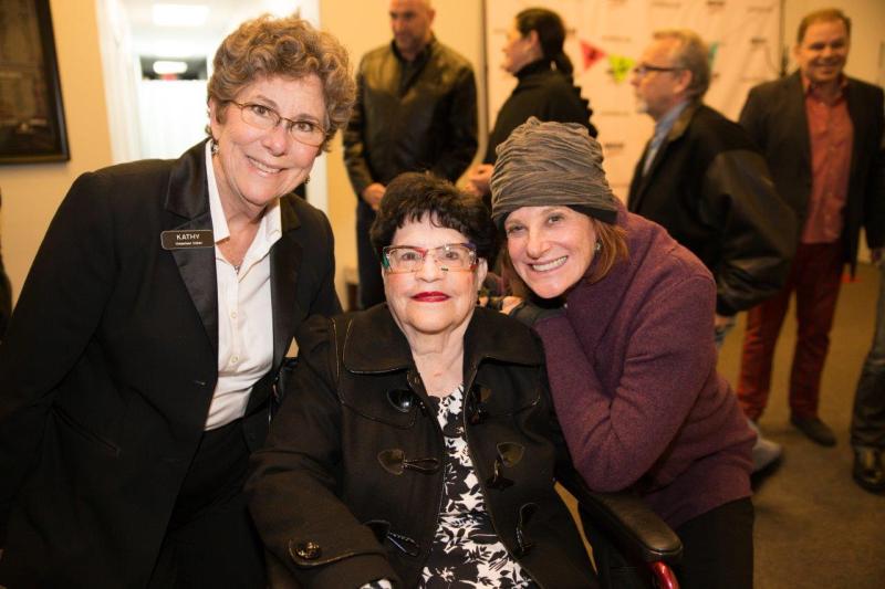 3 attendees posing for picture in theatre lobby after play reading.