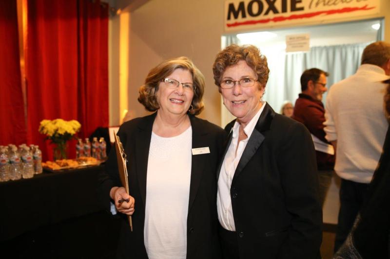 3 ushers in black jackets in theatre lobby after play reading.
