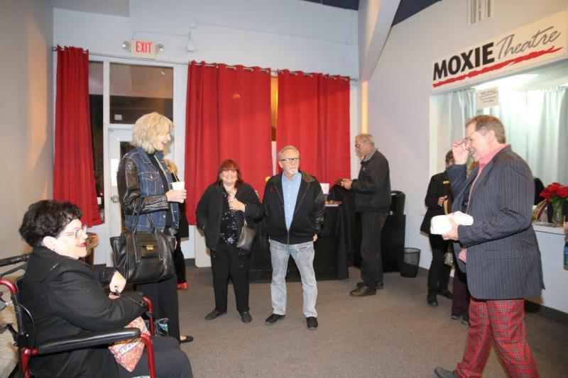 Phil Johnson talking to attendees in theatre lobby after play reading.