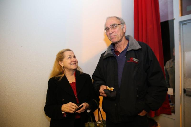 2 attendees visiting in theatre lobby after play reading.