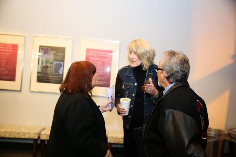 3 attendees catching up in MOXIE theatre lobby after reading.