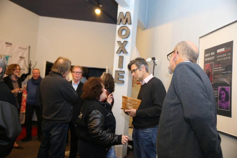 Attendees talking about the reading in MOXIE theatre lobby.