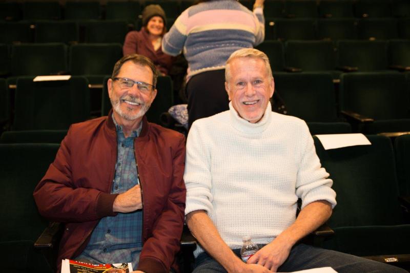 2 attendees seated in theatre before the reading.