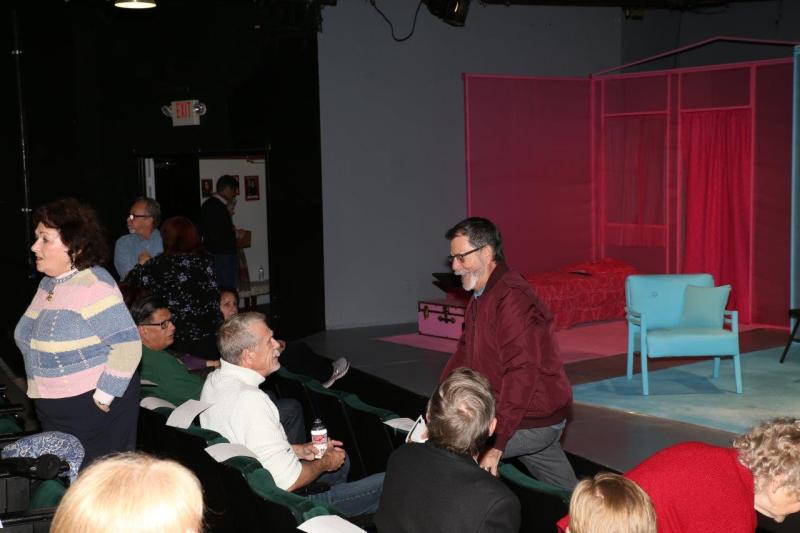 Attendees visiting in theatre before the reading.