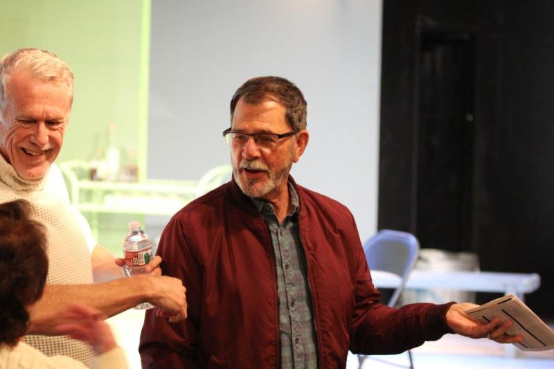 Attendees visiting in the theatre waiting for the reading to begin.