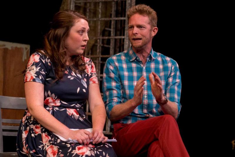 Woman in flowered dress discussing a scene with man in blue checked shirt .