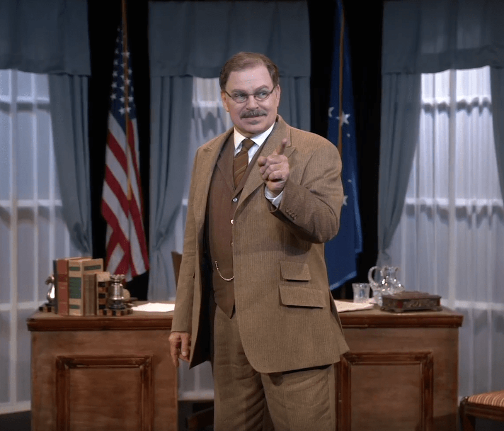 Actor Phil Johnson as President T. Roosevelt speaking to reporters in his White House office