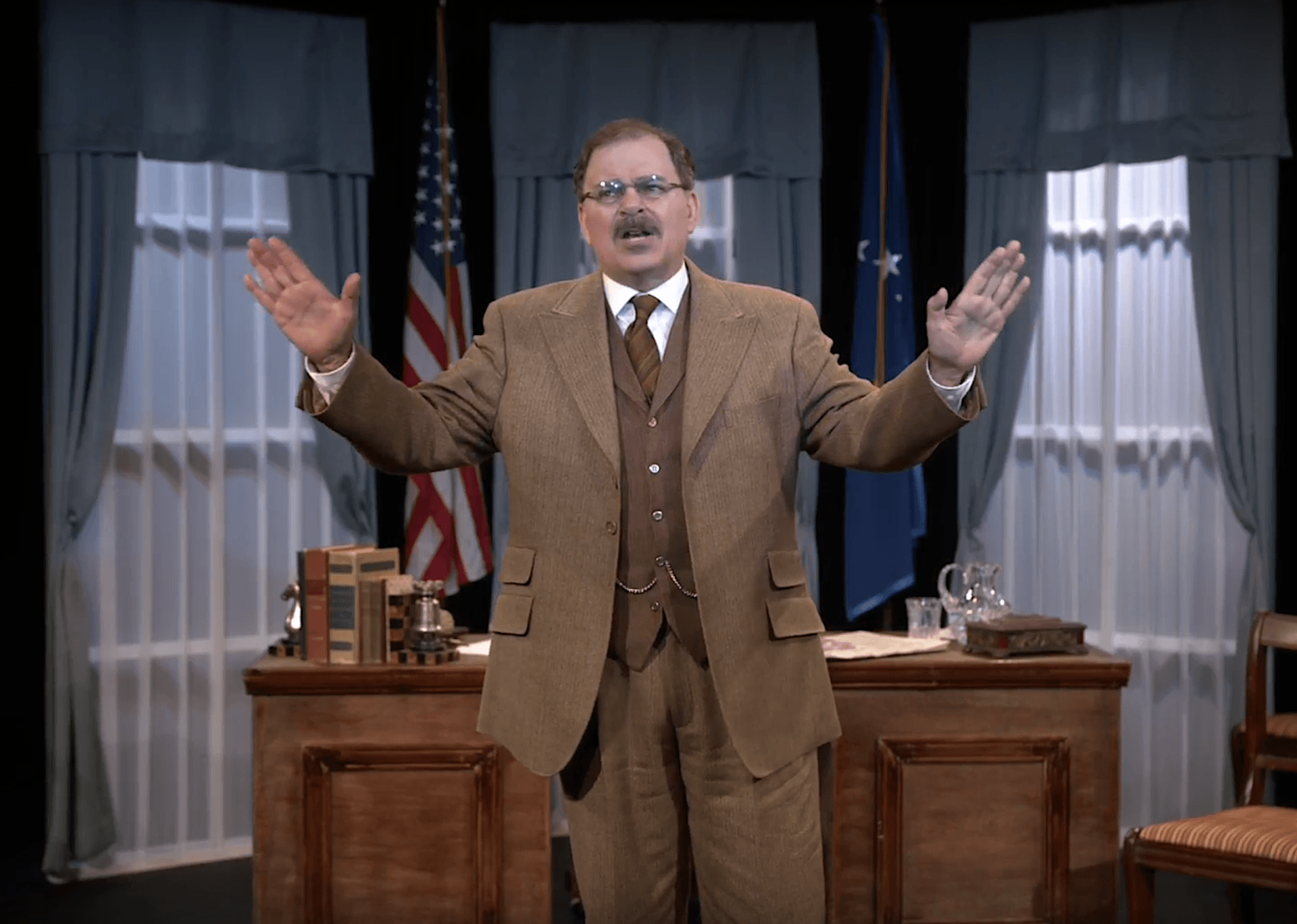 Actor Phil Johnson as President T. Roosevelt standing in front of his desk in his White House office