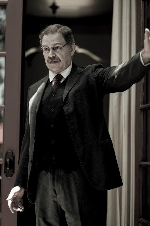 Actor Phil Johnson as President T. Roosevelt standing sideways in doorway