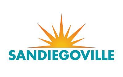 Logo for Sandiegoville, featuring teal text and a radiating golden sunburst on a white background.