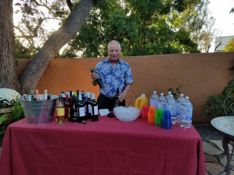 Man in blue flowered shirt at drinks table