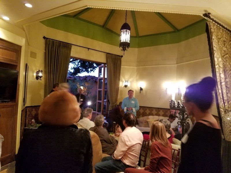 Group inside living room being welcomed by host