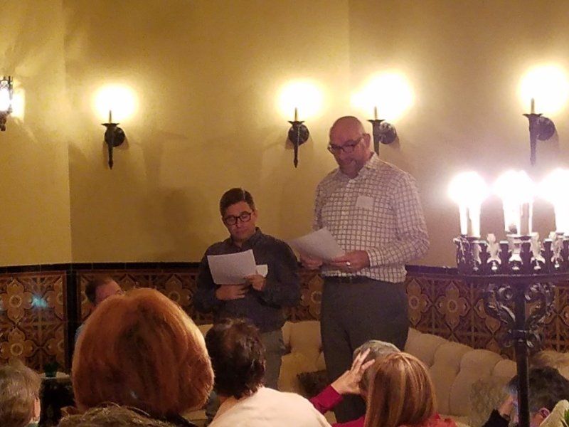 Omri and Ruff standing in living room reading from scripts