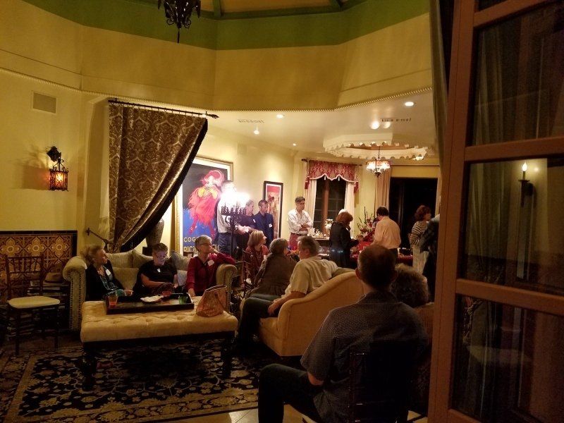 View of party guests inside living room and dining room