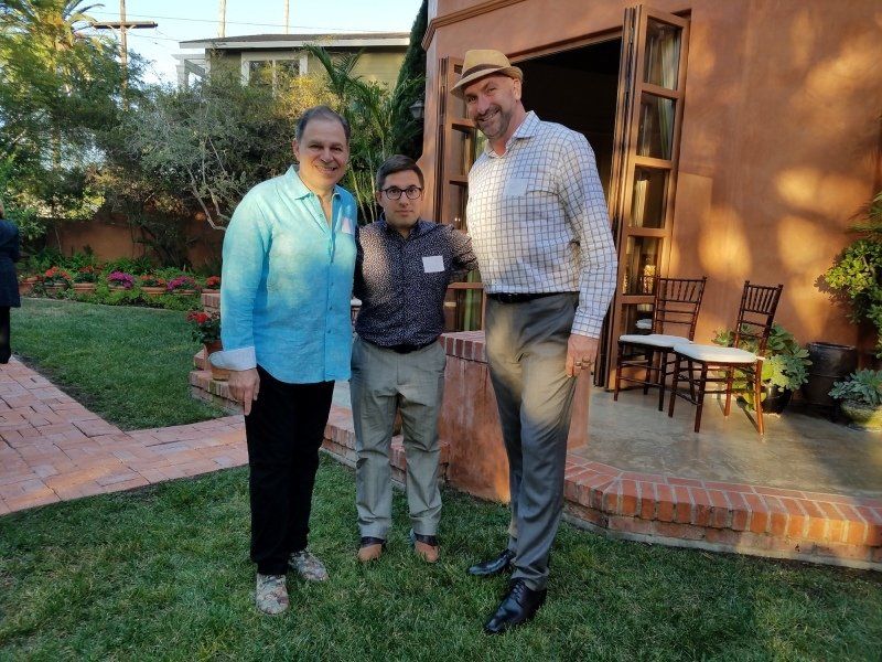3 men standing outdoors at party