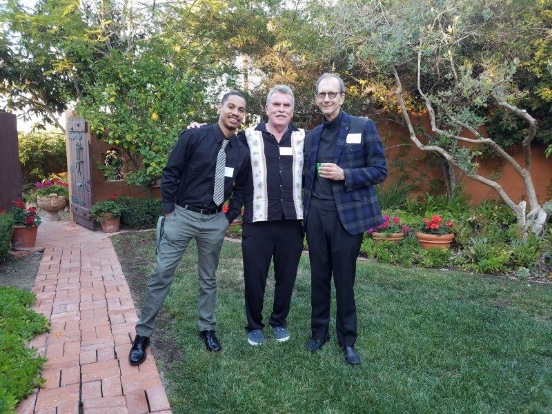 2 guests and Will standing outdoors at party