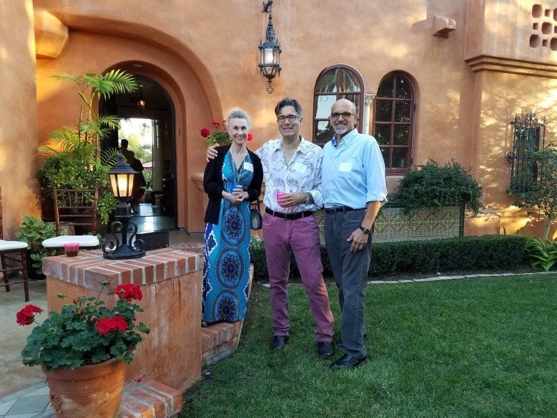2 guests and host Seth standing in front of a house at party