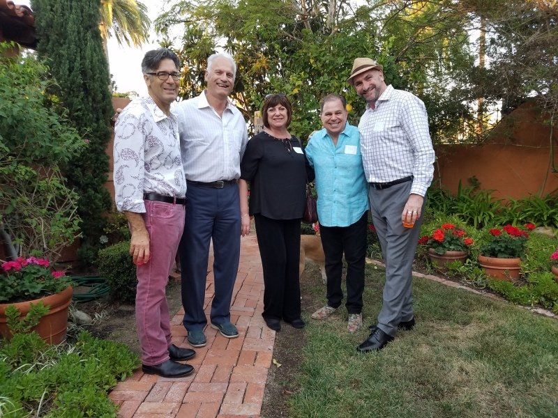 5 guests standing outdoors