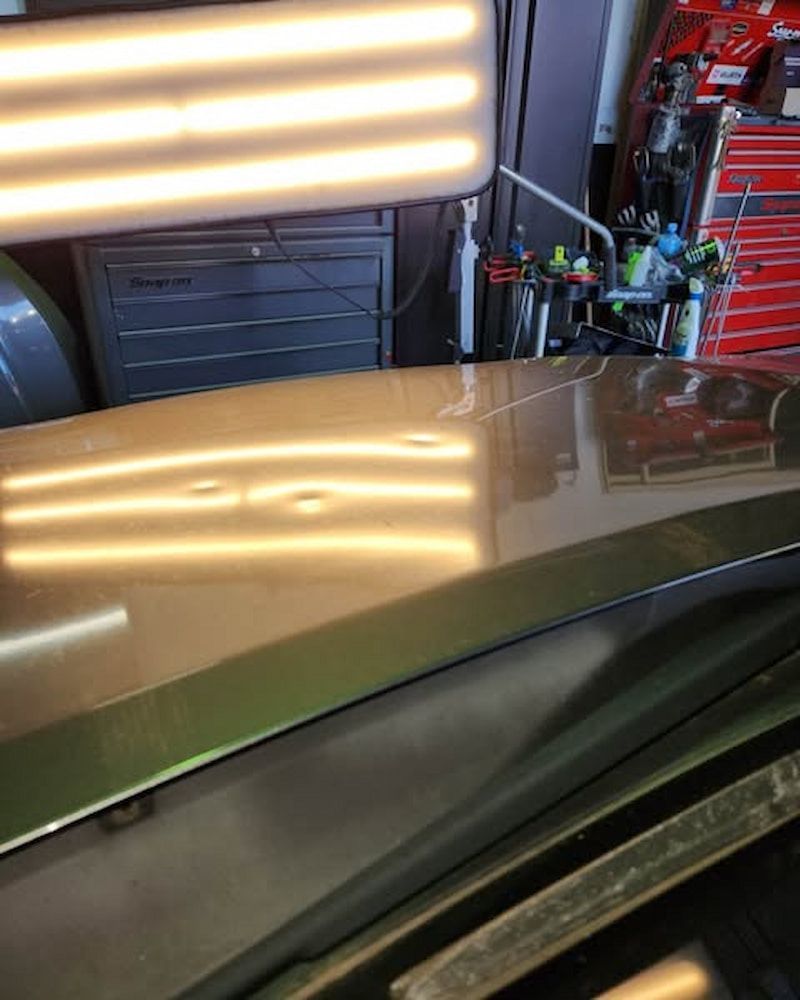 A Car Hood With a Light on It — Dynamic Dentz Smash Repair in South Nowra, NSW