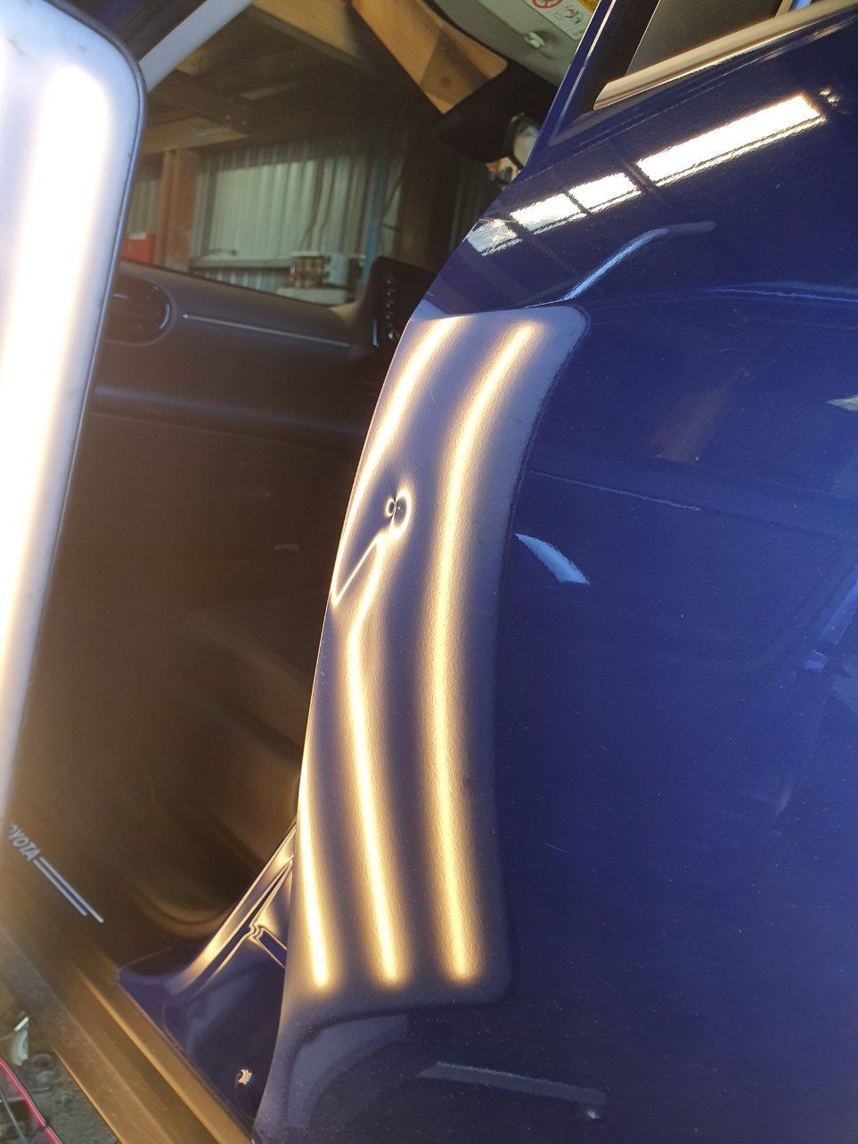 A Blue Car With a Dent on the Side of It — Dynamic Dentz Smash Repair in South Nowra, NSW